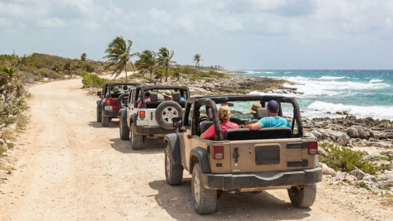 A convoy of open-top jeeps driving the rugged coastal road of Cozumel