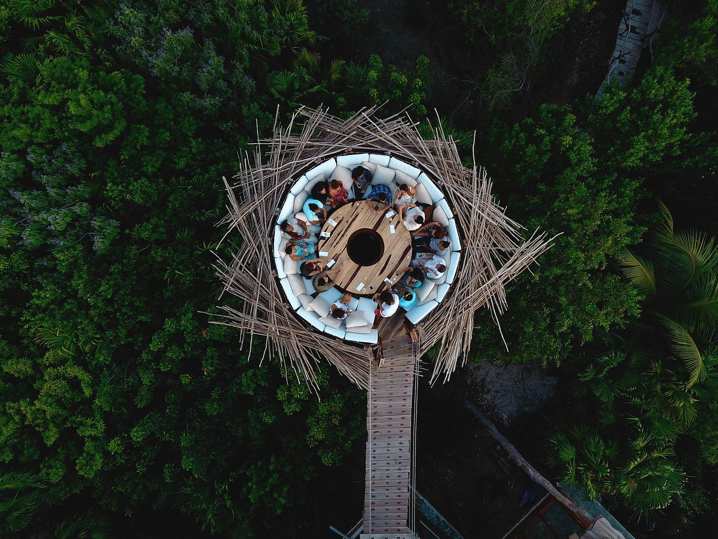 Aerial of Azulik's circular bamboo nest dining pod suspended over dense jungle canopy