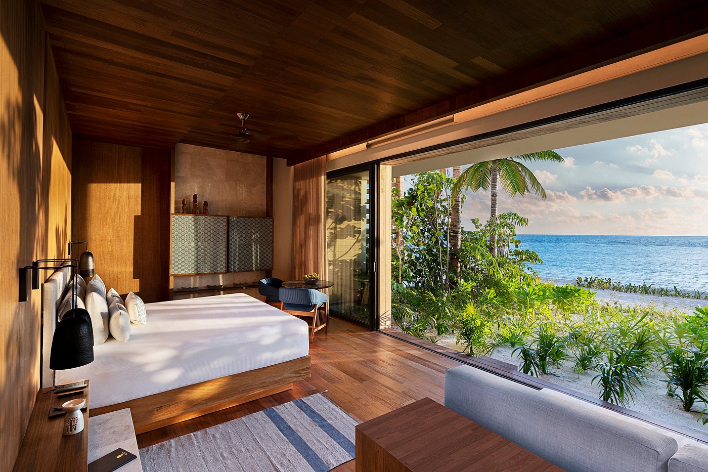An Asian-inspired courtyard with a reflecting pond and red lantern-hung tree at Banyan Tree Mayakoba