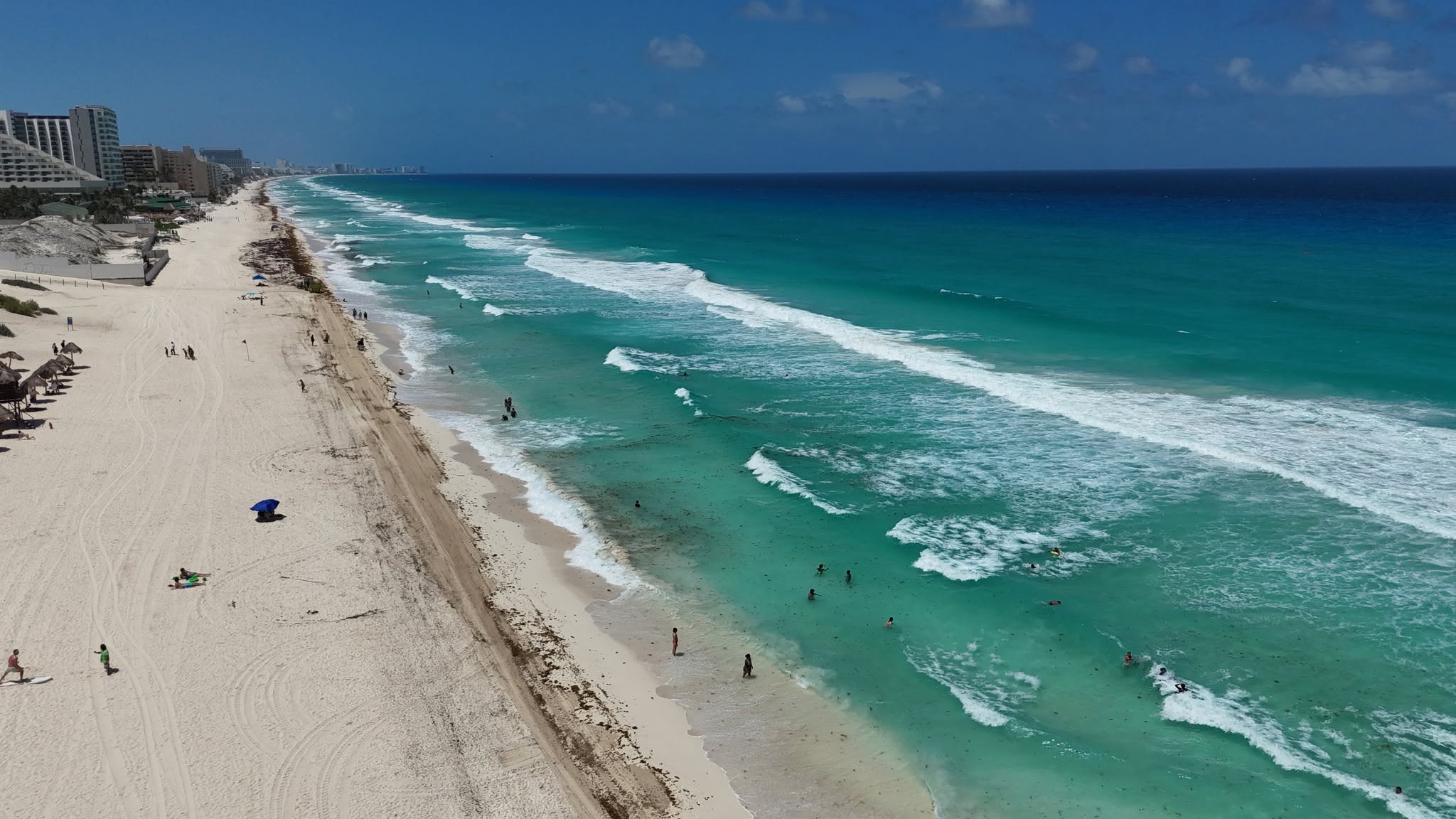 Aerial view of Playa Delfines in Cancún, with wide white sand and clear turquoise water
